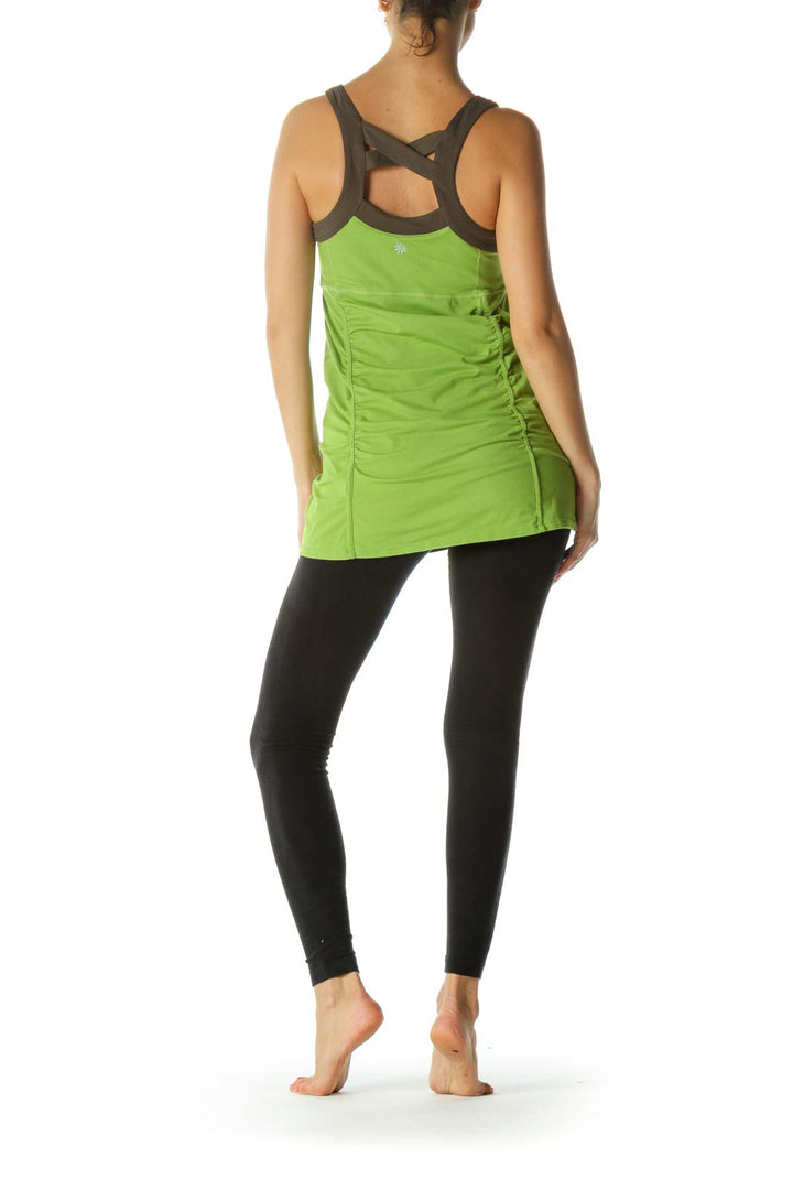 Back view of green Athleta tank top showing cross-strap design