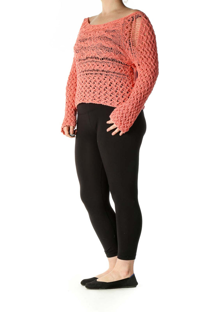 Front view of Free People coral crochet knit crop sweater with intricate open-knit pattern