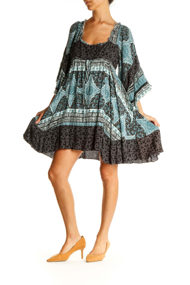 Front view of Free People blue and black patterned boho mini dress with bell sleeves