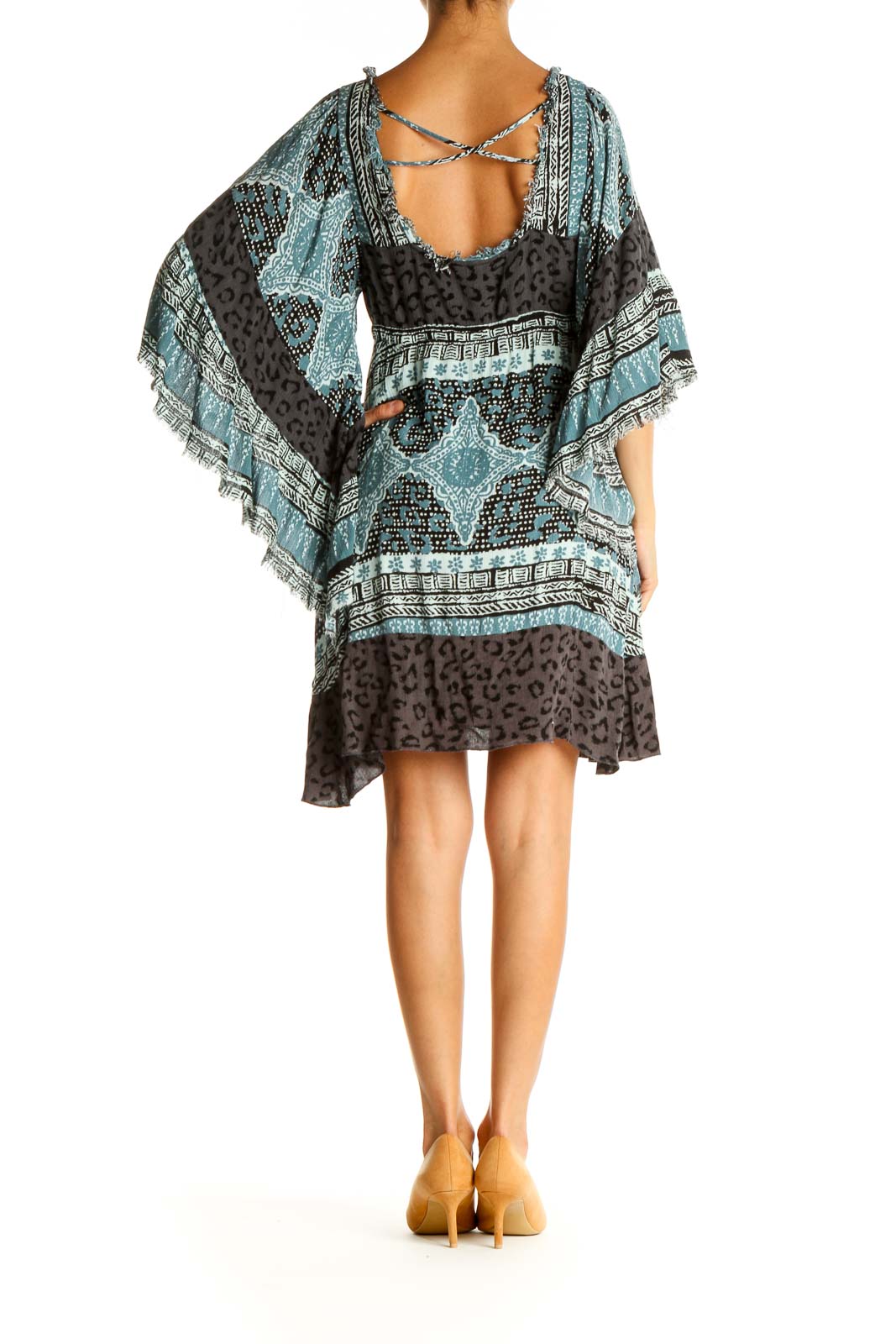 Back view of Free People blue and black patterned boho mini dress showing open back design