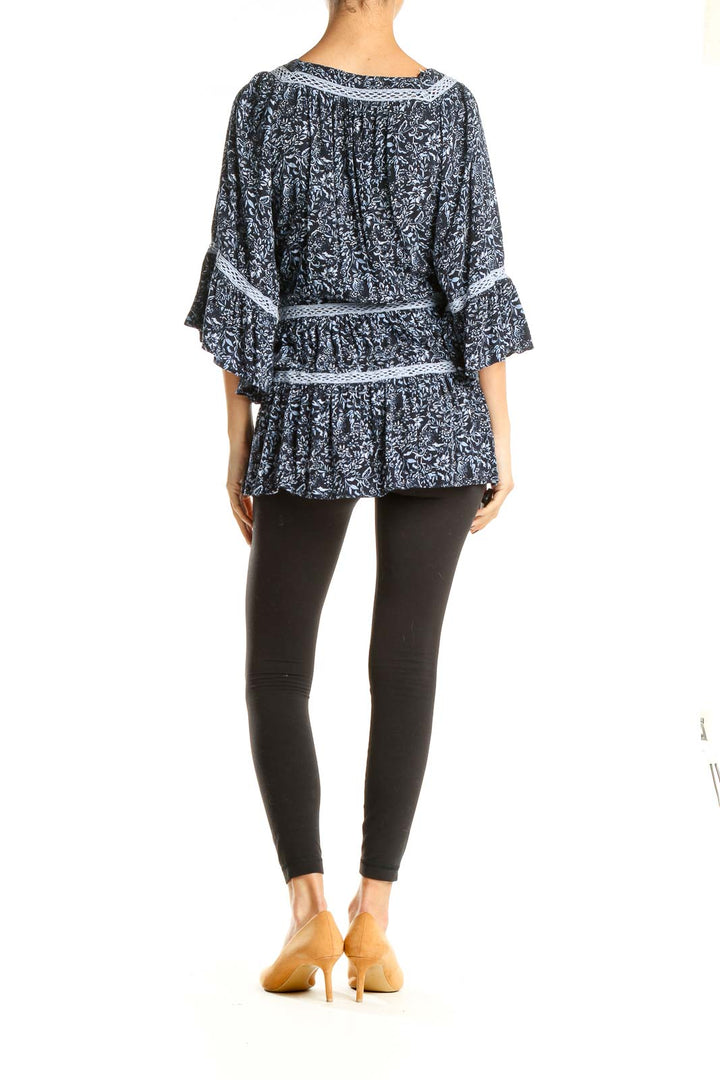 Back view of Free People blue floral tiered tunic top with bell sleeves