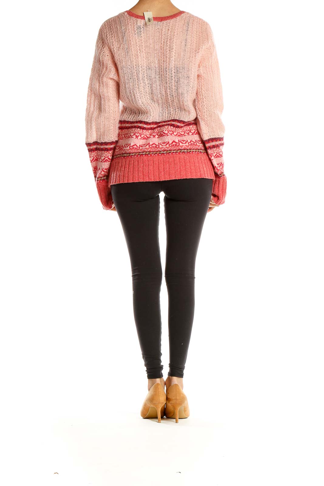 Side view of model wearing pink and coral DKNY Jeans knit sweater with black leggings