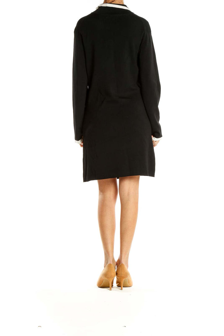Side view of Coldwater Creek black knit cardigan showing long-line silhouette and white trim details