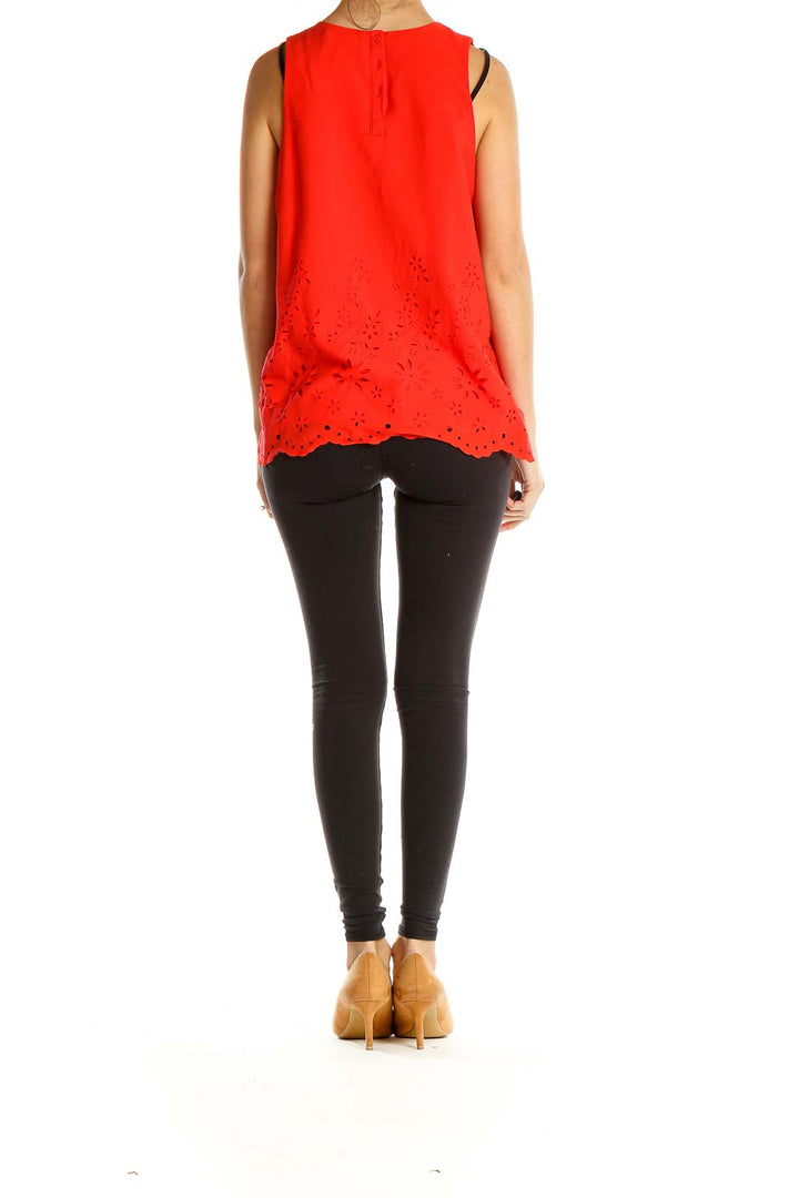 Side view of red sleeveless Cynthia Rowley top showing eyelet lace detail