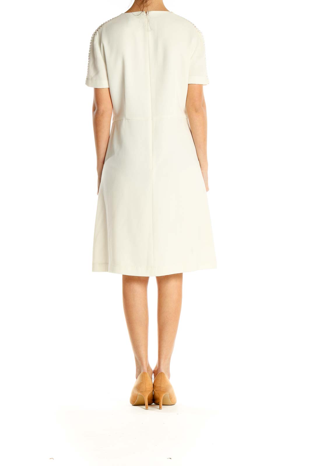 Side view of ivory BCBG MaxAzria A-line dress showing sleeve cutouts and silhouette