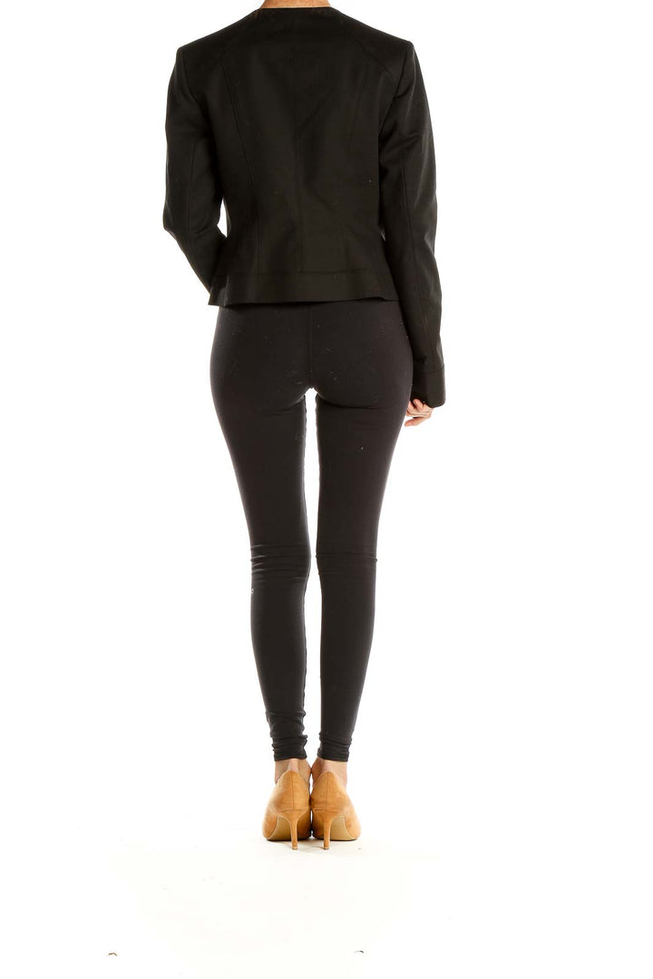 Side view of Tahari black asymmetrical zip-front cropped jacket on model