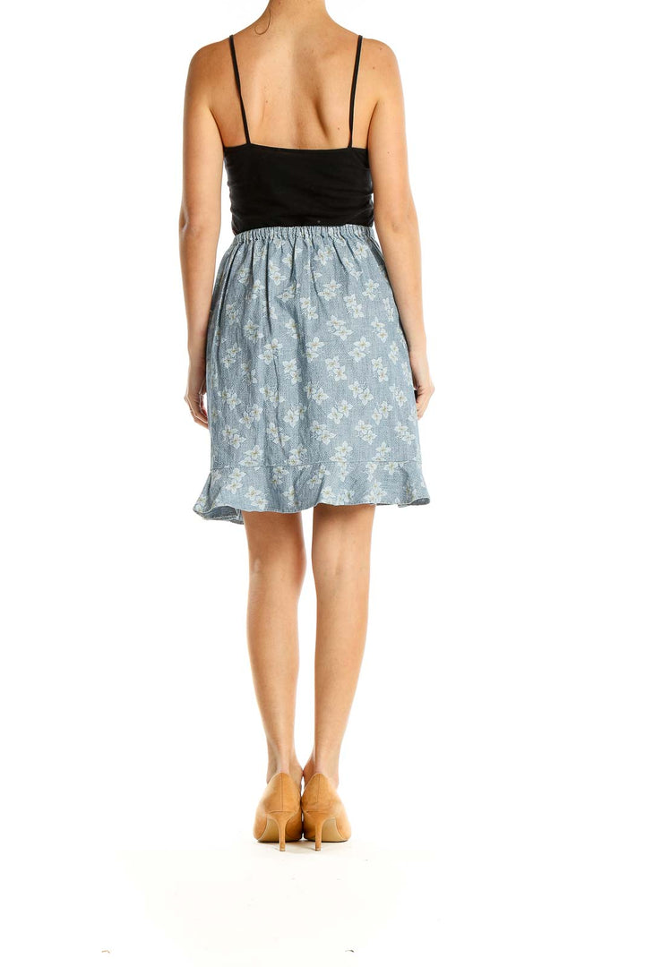 Side view of J.Crew Mercantile blue floral wrap skirt showing tie detail