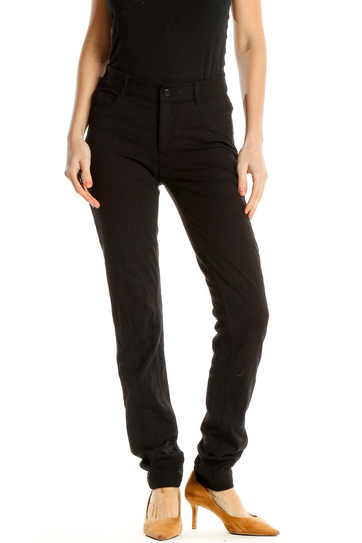Front view of black Athleta slim-fit athletic pants on model