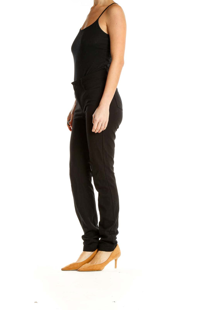 Front view of black Athleta slim-fit athletic pants on model