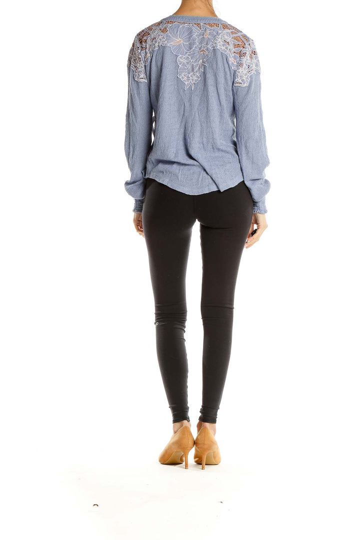Back view of Free People blue Henley top showing lace detail