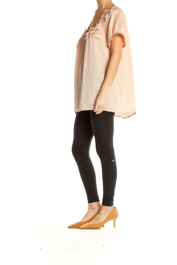 Front view of blush Ann Taylor LOFT blouse with ruffled neckline
