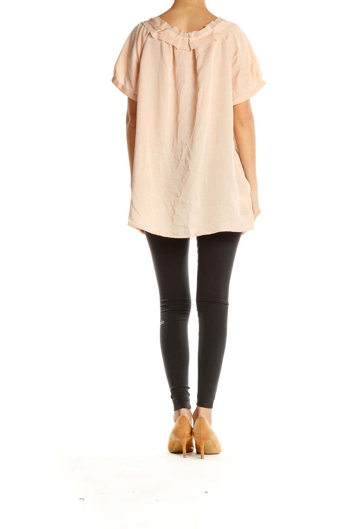 Side view of blush Ann Taylor LOFT blouse showing drape and fit