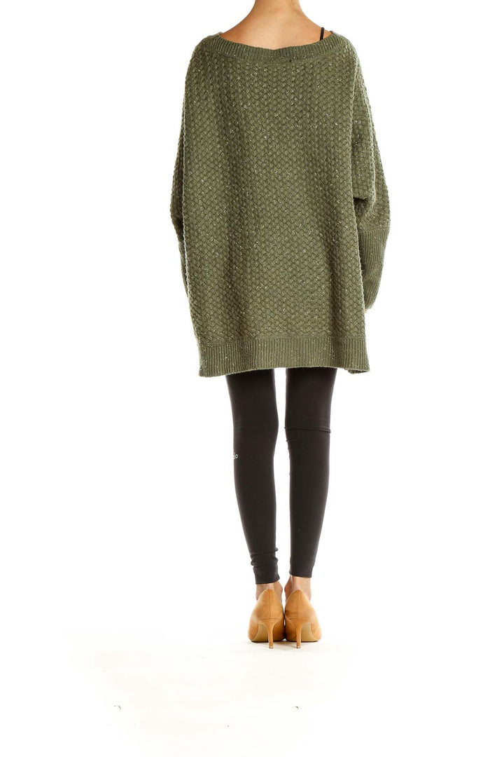 Side view of olive green oversized textured knit sweater from Lane Bryant on model