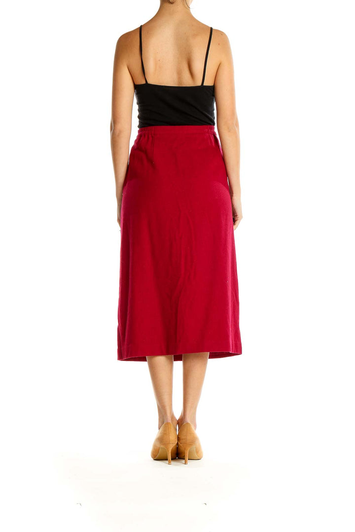 Side view of Leslie Fay red A-line midi skirt on model with black top