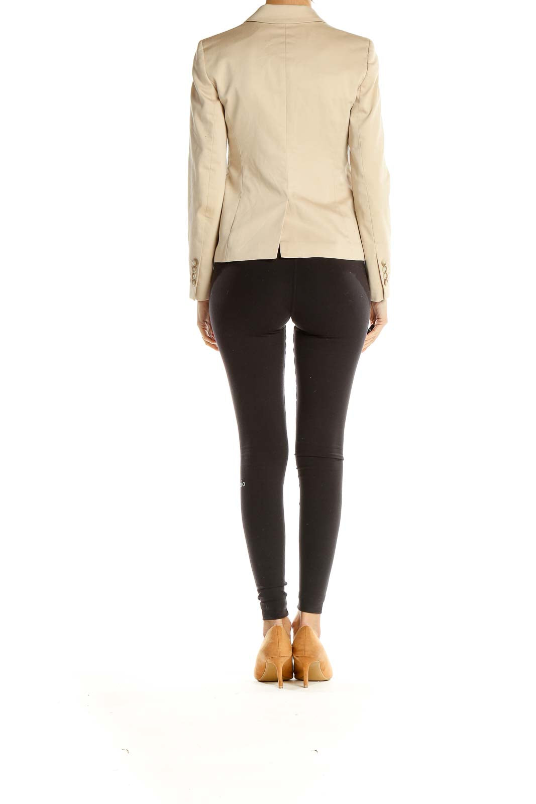 Side view of Ann Taylor beige blazer worn with black pants