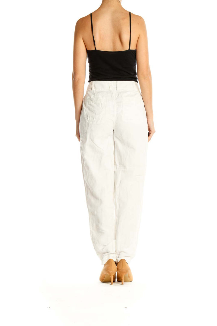 Side view of Nordstrom Signature white pleated straight-leg trousers on model