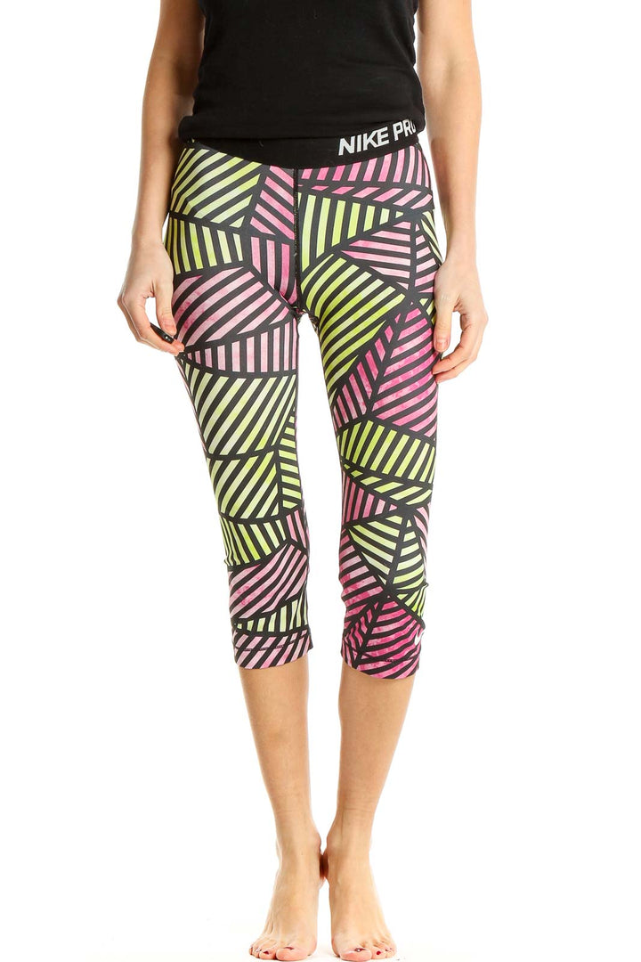 Front view of Nike Pro capri leggings with pink and yellow geometric print