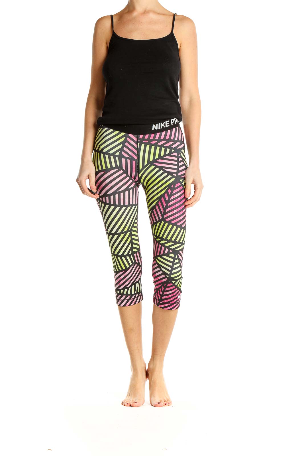 Front view of Nike Pro capri leggings with pink and yellow geometric print
