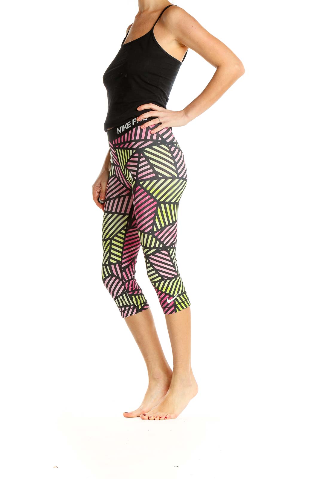 Front view of Nike Pro capri leggings with pink and yellow geometric print