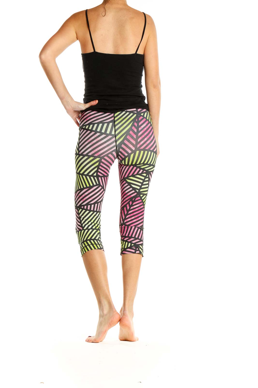 Side view of woman wearing Nike Pro capri leggings with geometric print