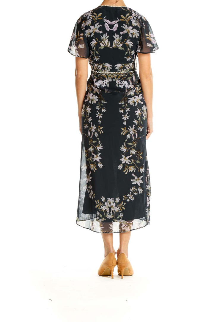 Side view of Hope & Ivy black floral chiffon midi dress showing high-low hemline