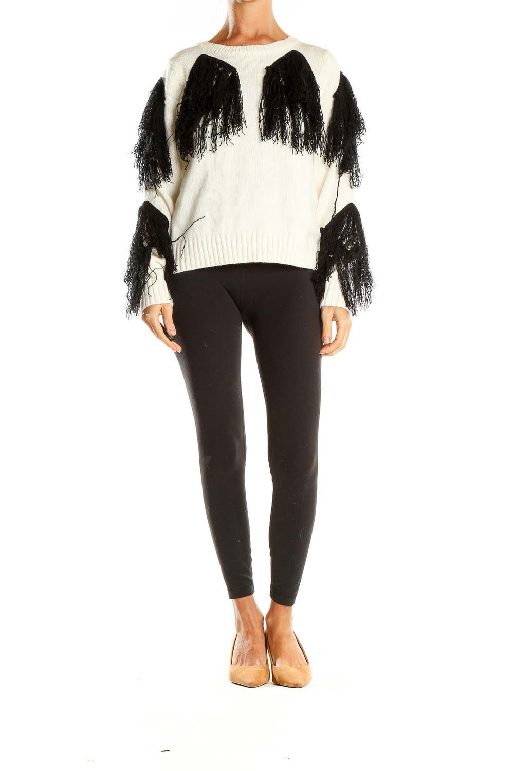 Front view of white knit sweater with black fringe detailing on sleeves and body