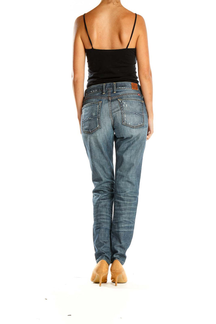 Side view of Lucky Brand blue distressed straight leg jeans on model