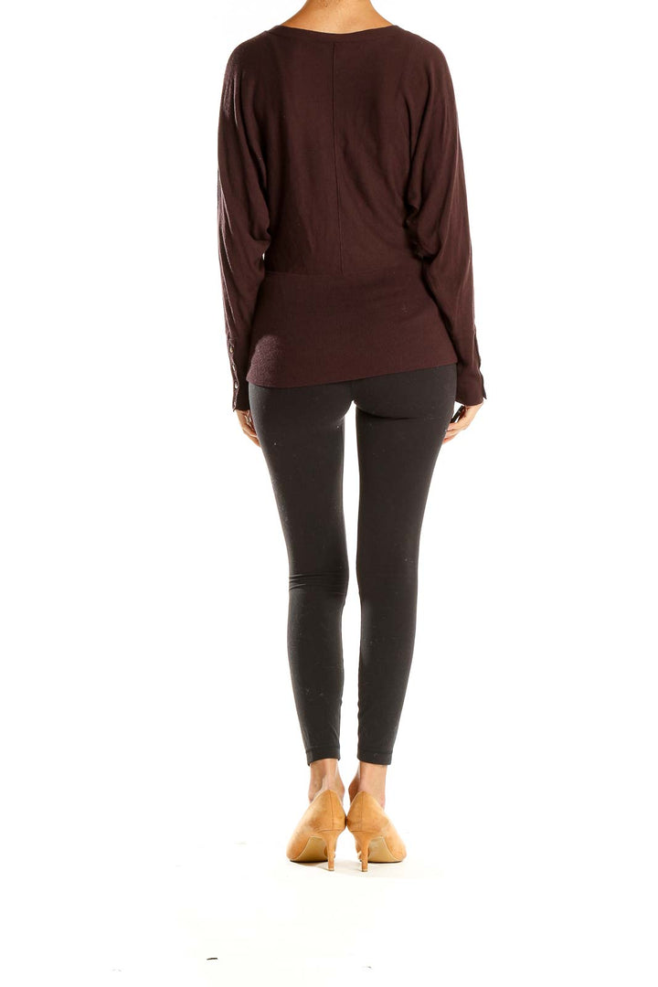Side view of LOFT brown V-neck long sleeve knit sweater paired with black leggings