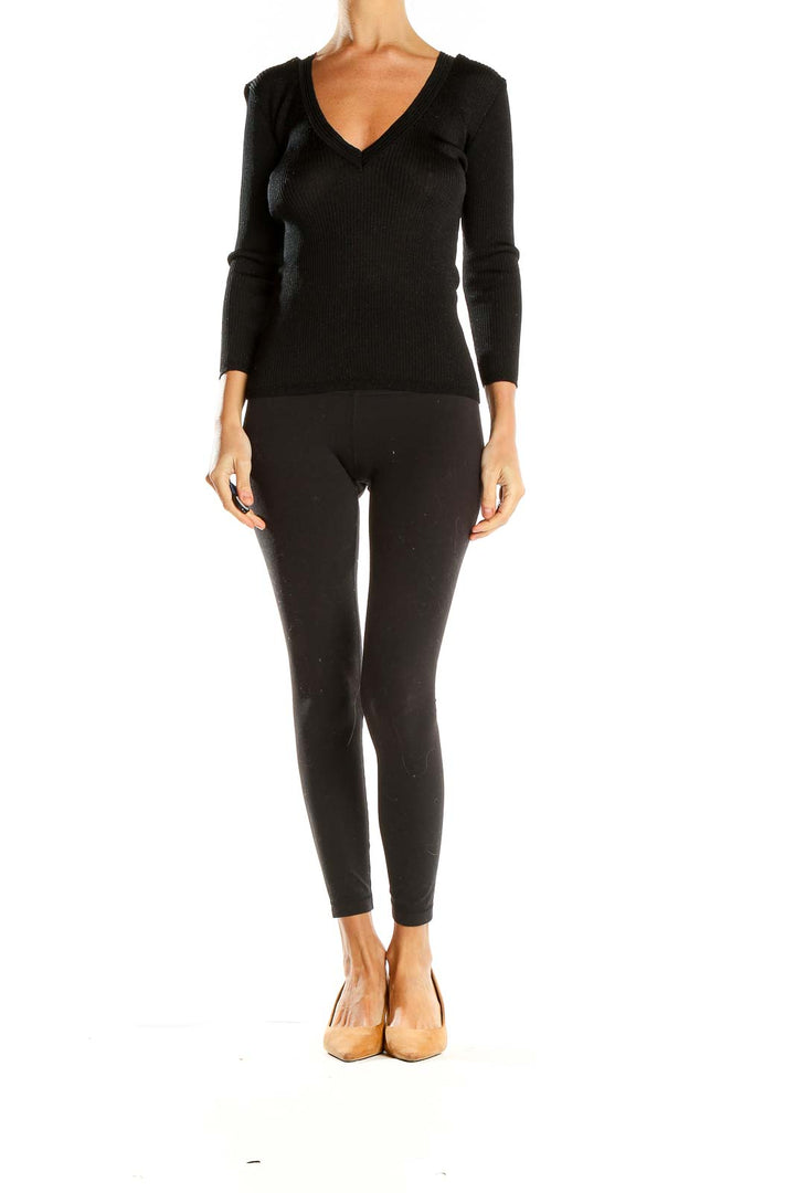 Front view of ICB black V-neck ribbed knit sweater on model