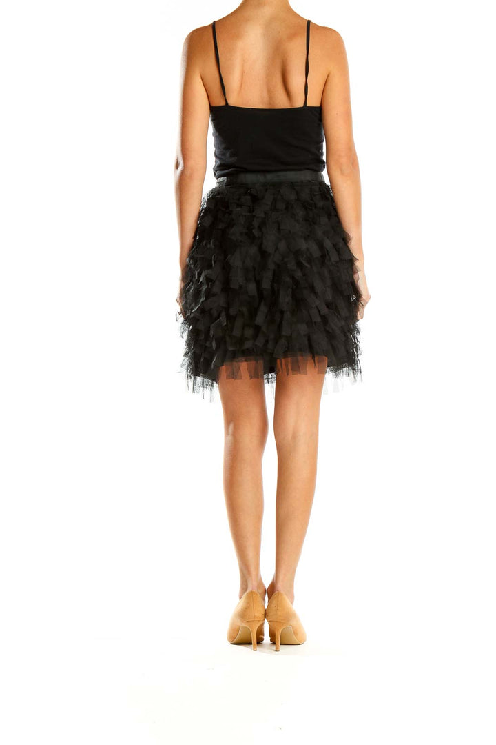 Side view of LOFT black ruffled tulle mini skirt on model