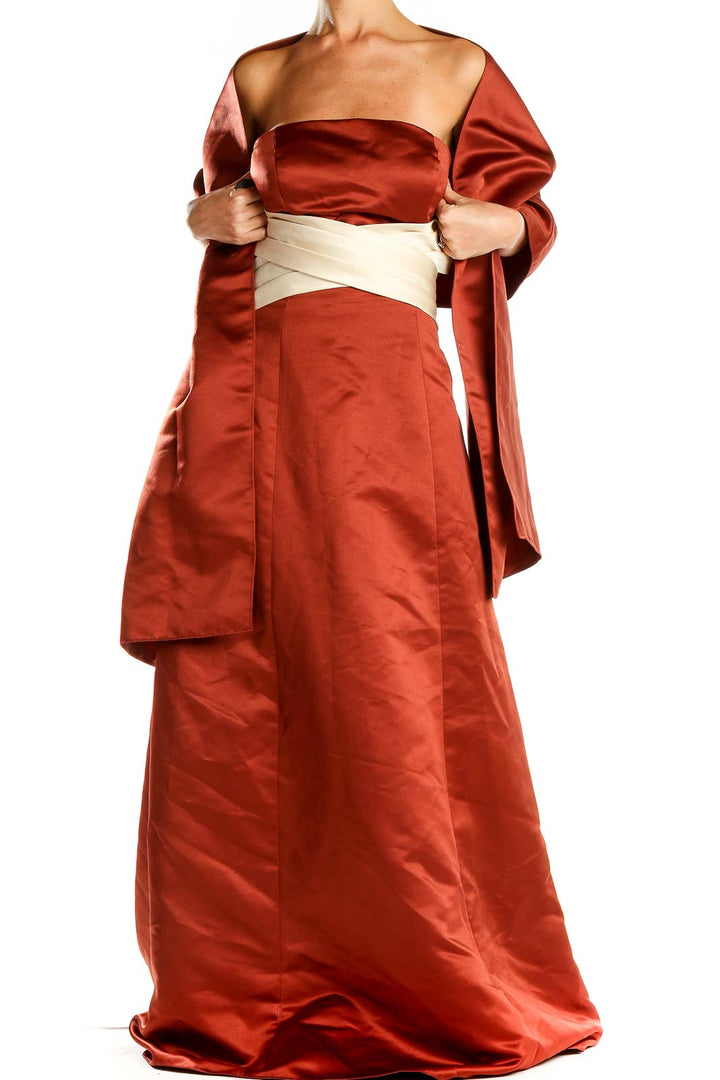 Front view of rust-colored Bill Levkoff strapless satin evening gown with cream sash