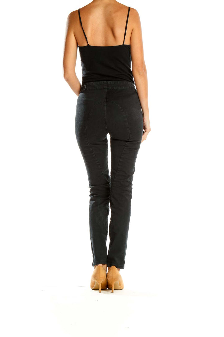 Side view of Rag & Bone black slim-fit pants showing zipper accents