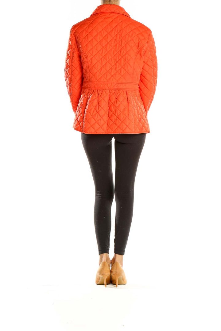 Side view of Lauren Ralph Lauren orange quilted jacket on model