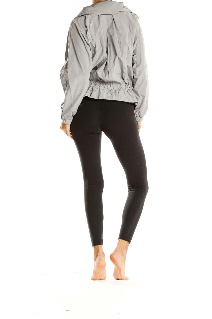 Back view of gray GapFit lightweight hooded zip-up jacket on model