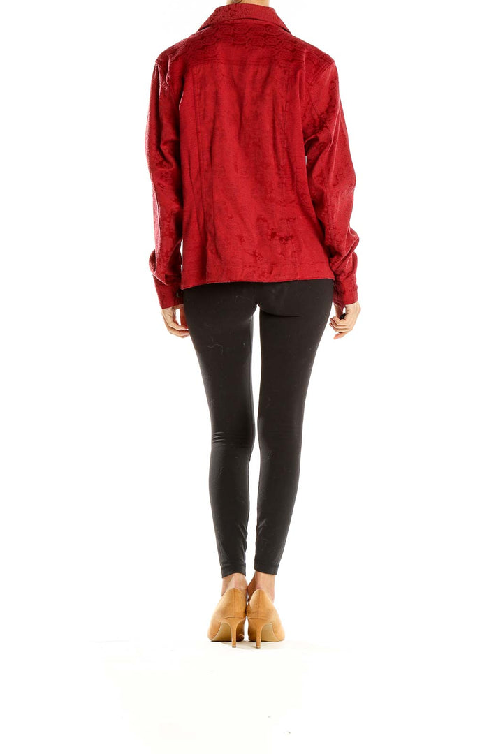 Side view of woman wearing red textured button-up jacket from Christopher and Banks
