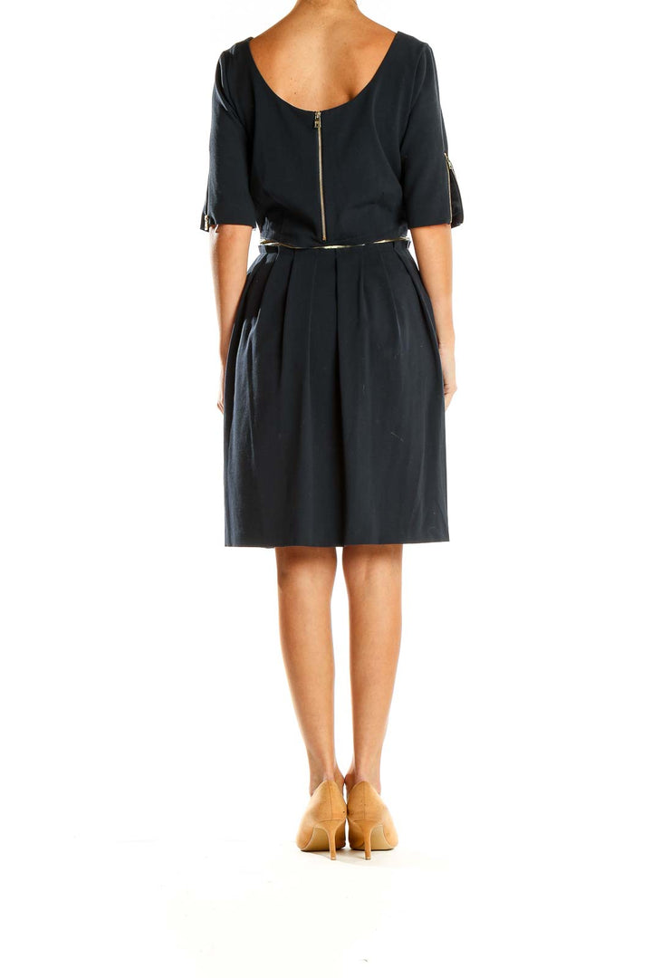 Side view of black MARC NEW YORK ANDREW MARC cocktail dress showing pleated skirt and elbow-length sleeves