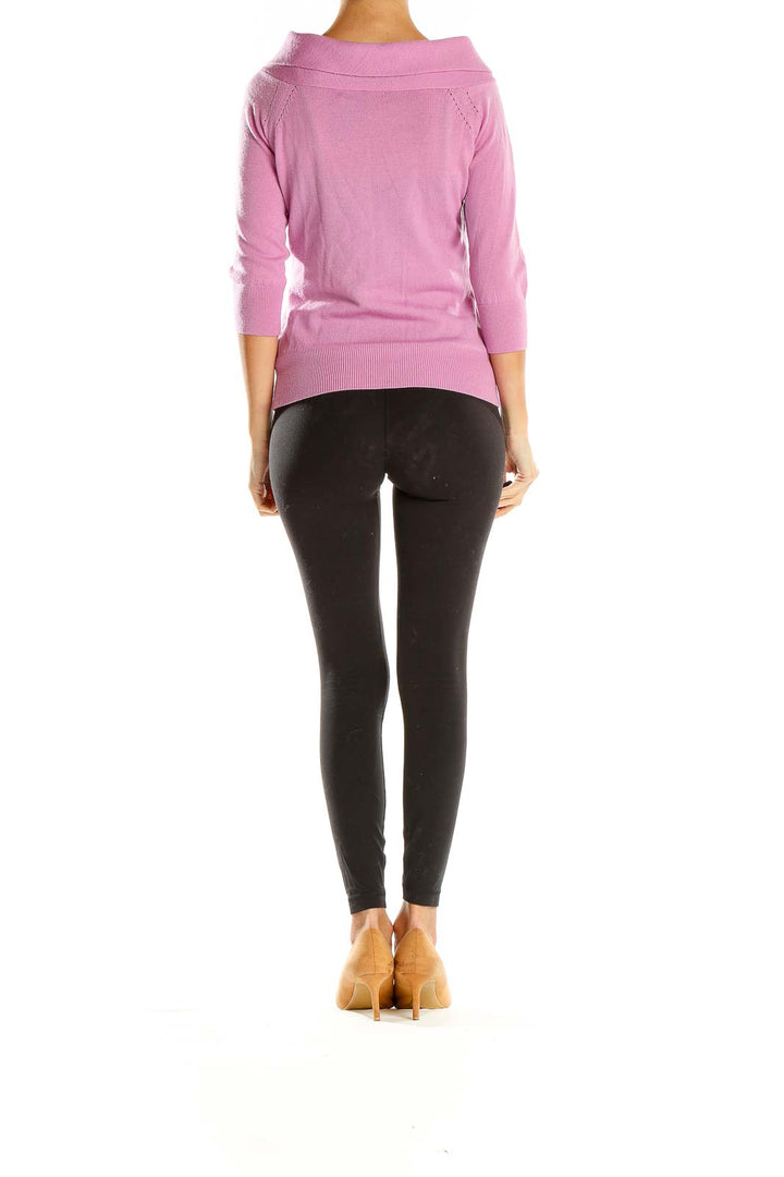 Side view of pink Banana Republic knit sweater on model with black pants