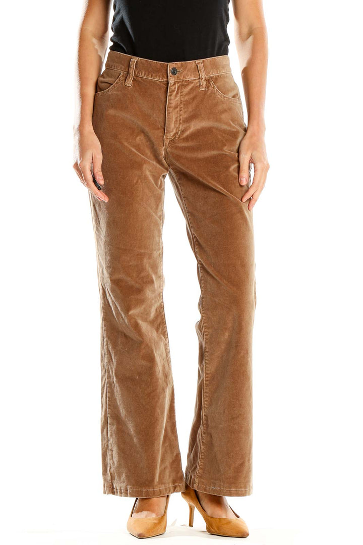 Front view of tan Gap corduroy flare pants on model