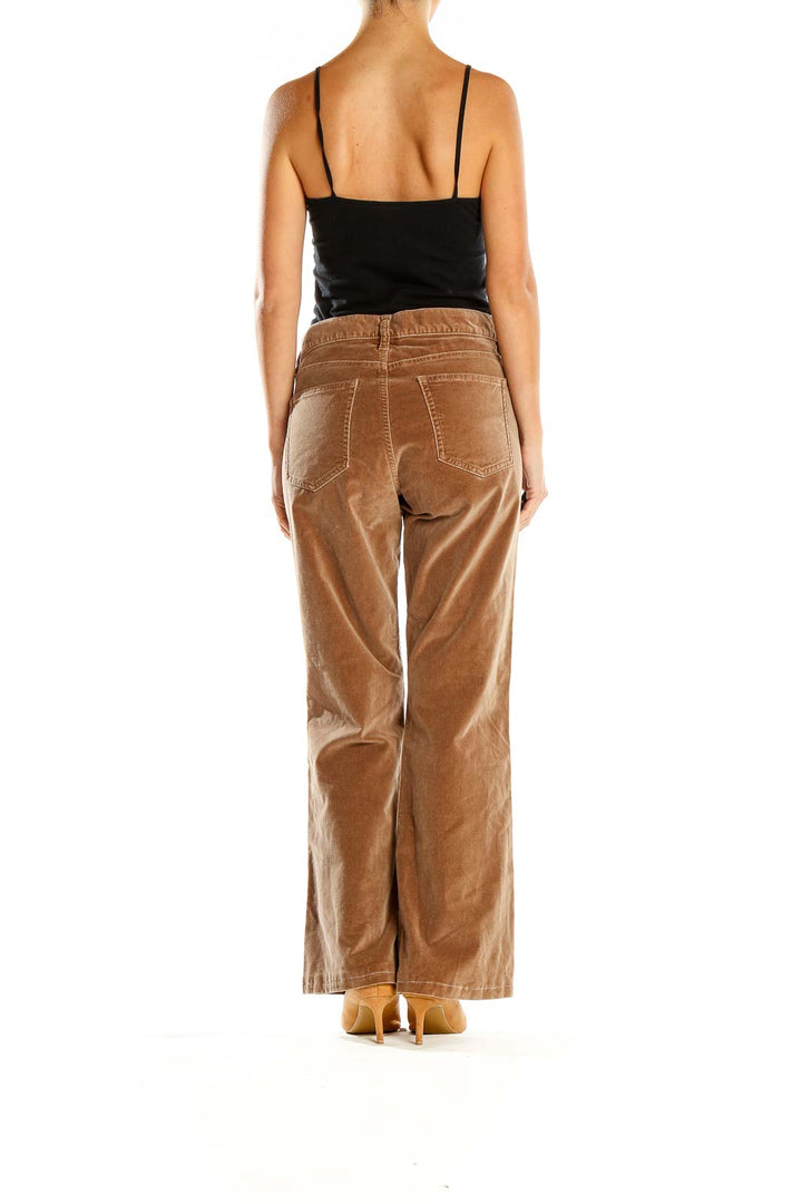 Back view of tan Gap corduroy flare pants on model