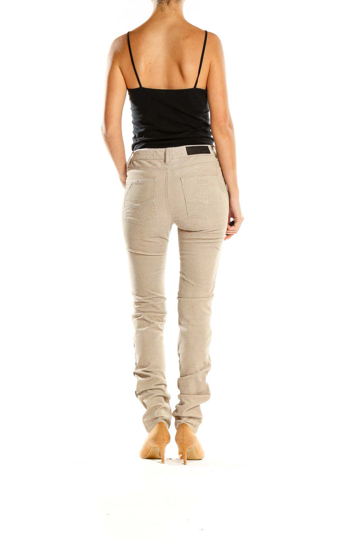Side view of woman wearing Zadig & Voltaire beige corduroy pants with black top