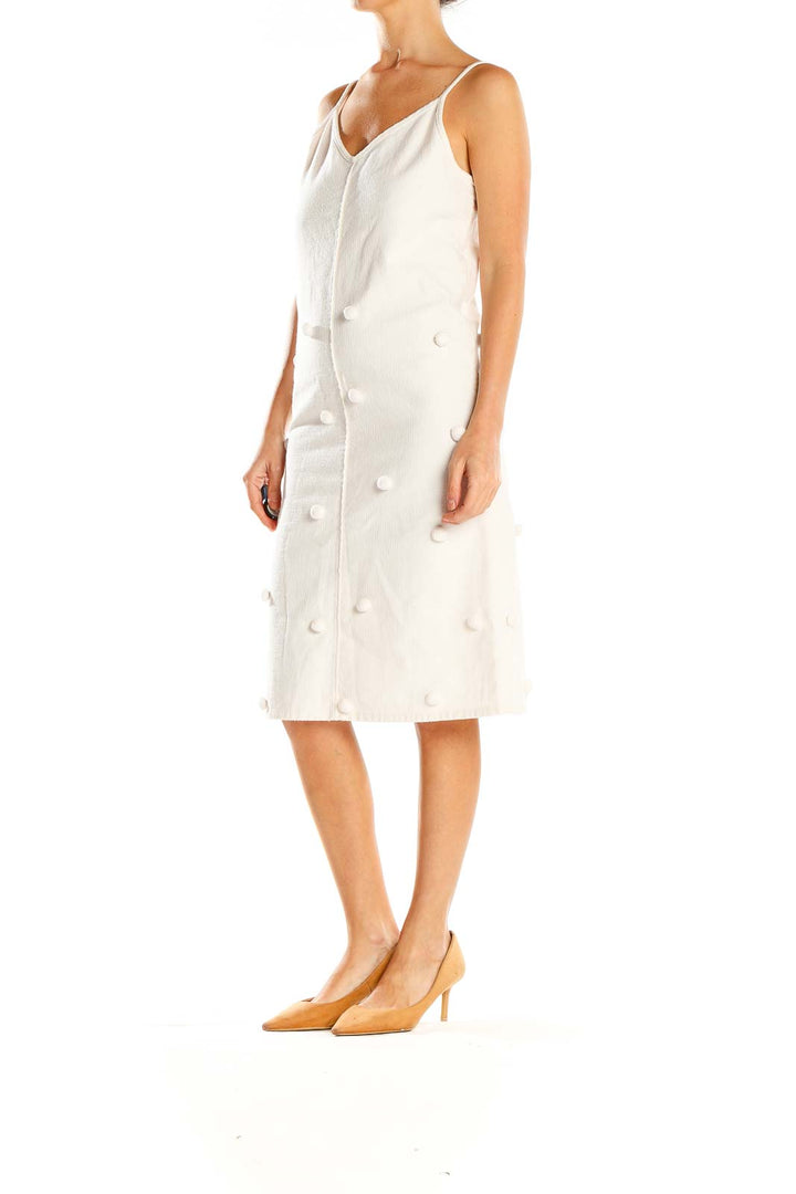 Front view of Apiece Apart white textured button-front midi dress with spaghetti straps