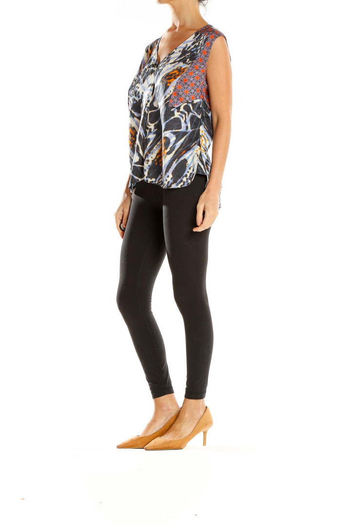 Front view of Rachel Roy abstract print silk top in black, white, and orange