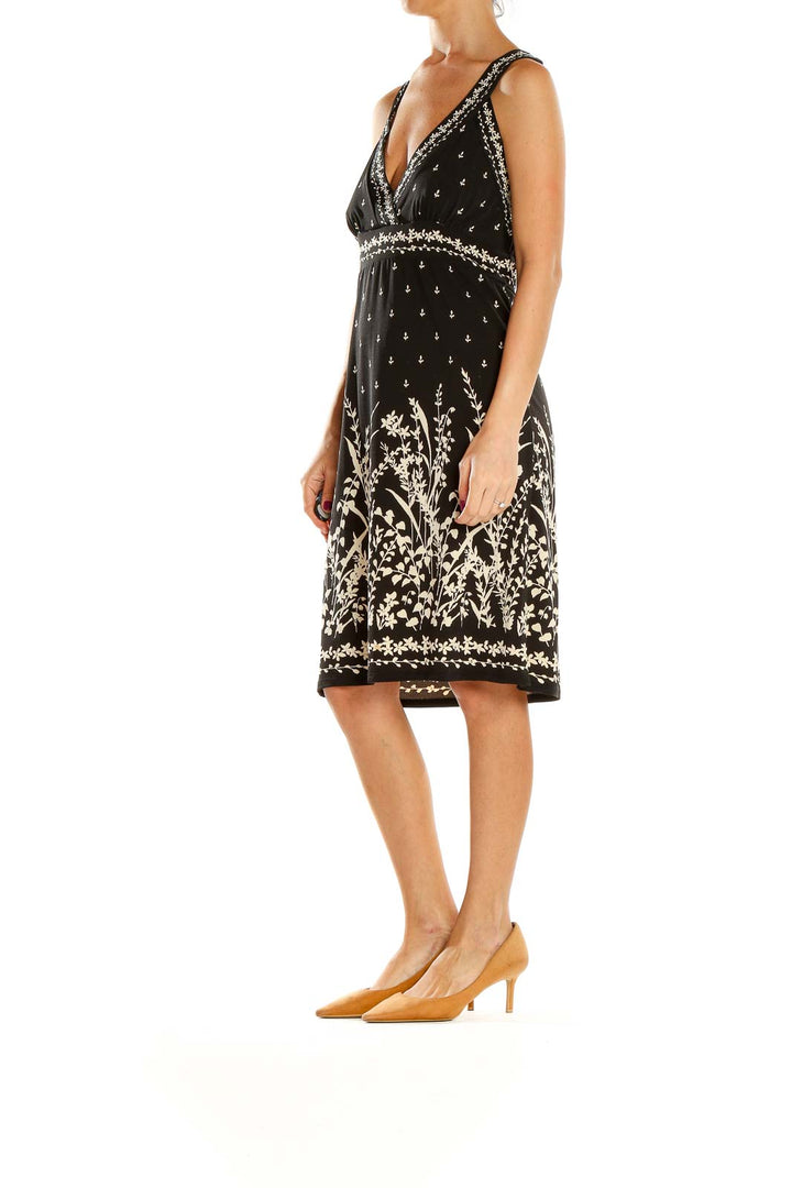 Front view of Max Studio black dress with floral embroidery and beaded v-neckline