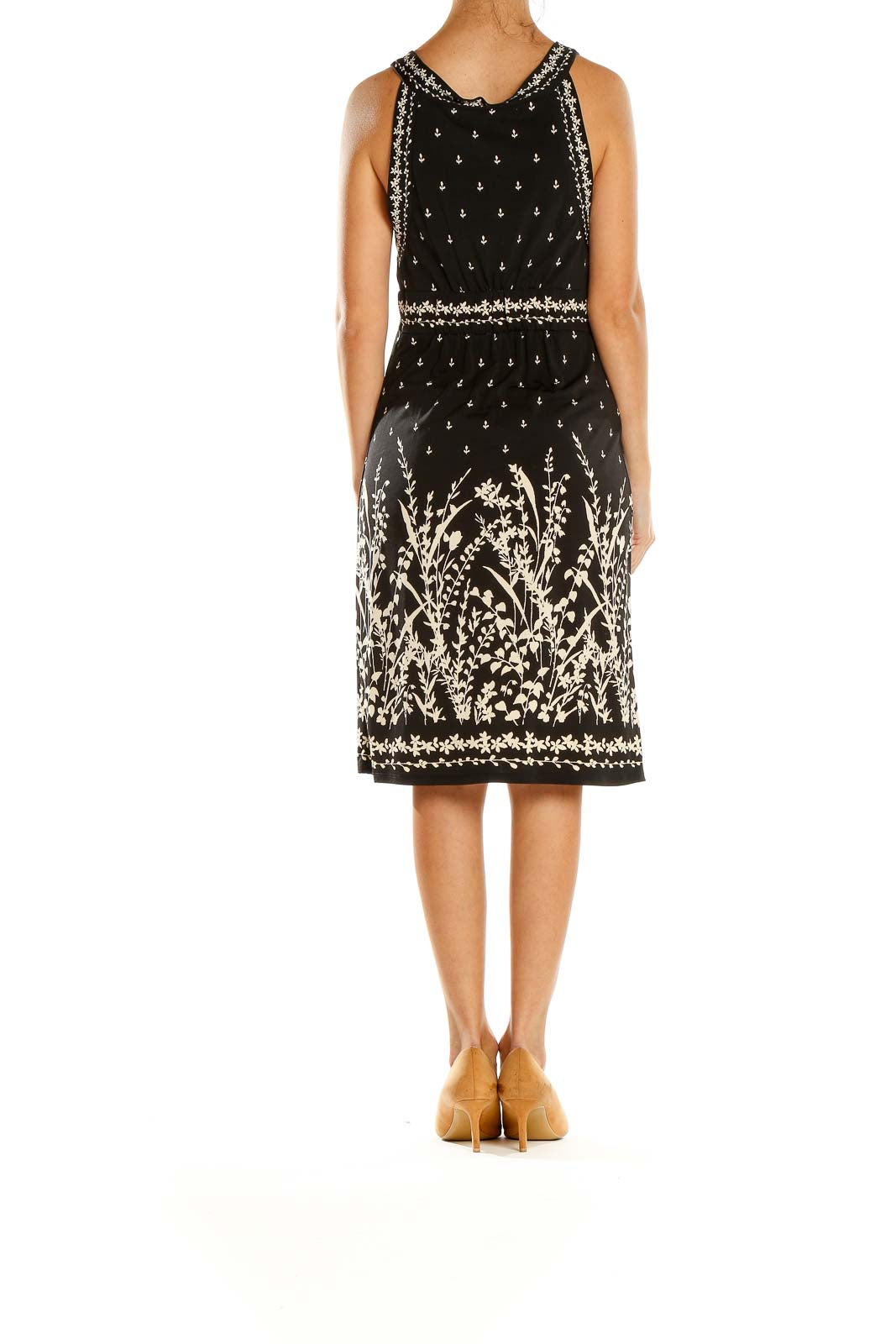 Side view of Max Studio black dress showing empire waist and floral embroidered hem