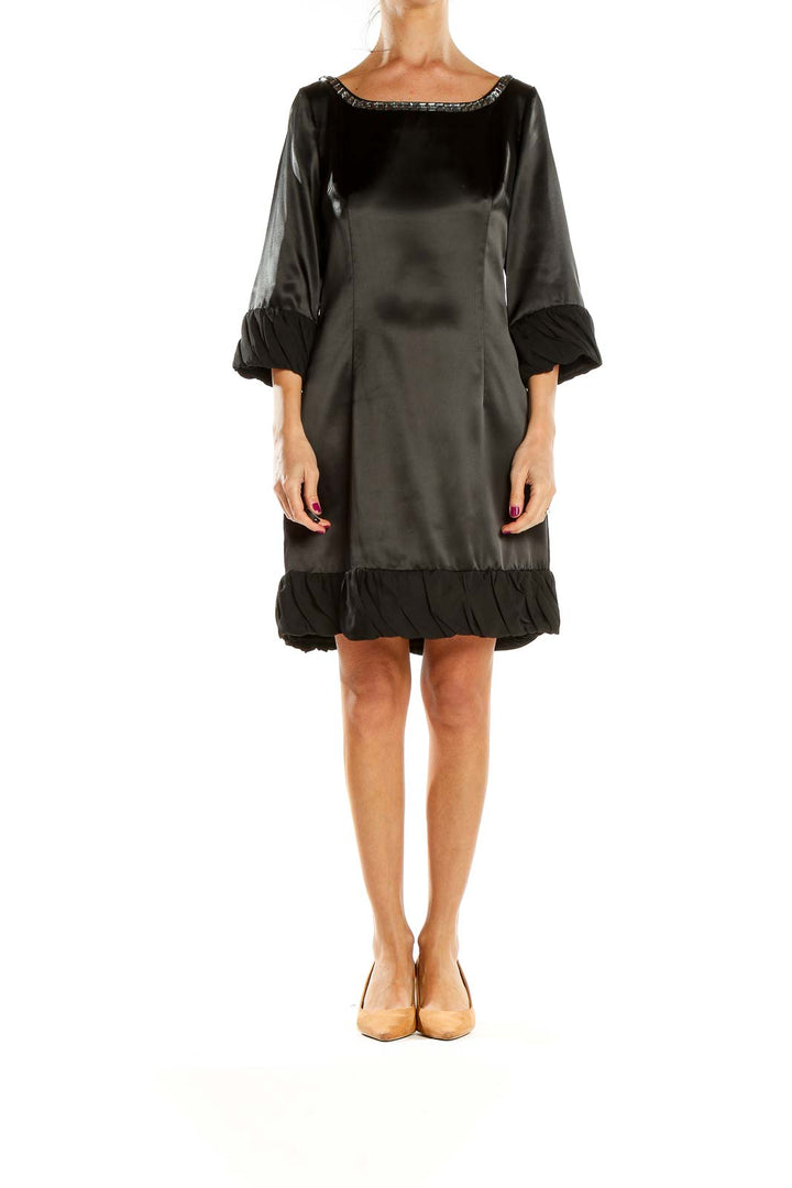 Front view of Pollini black satin cocktail dress with beaded neckline and ruffle trim