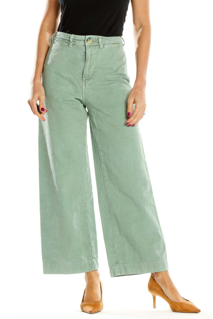 Front view of WE THE FREE sage green wide-leg pants on model