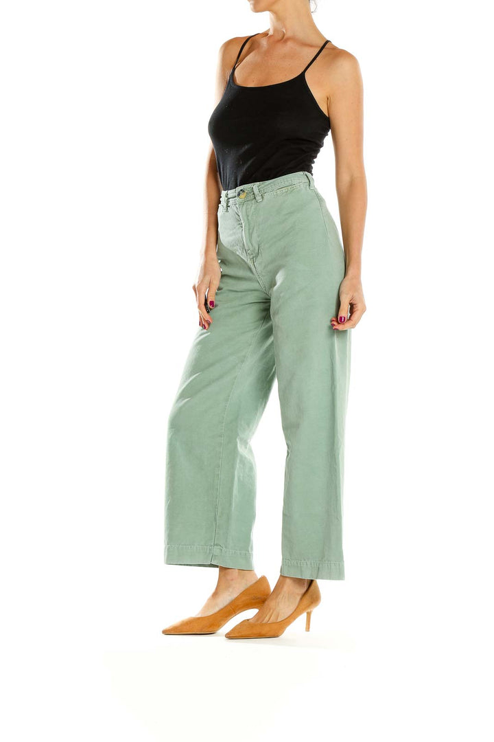 Front view of WE THE FREE sage green wide-leg pants on model