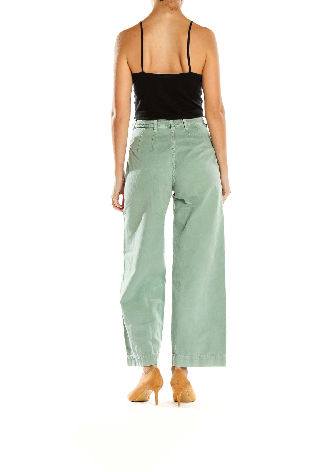 Side view of WE THE FREE sage green wide-leg pants on model with black top