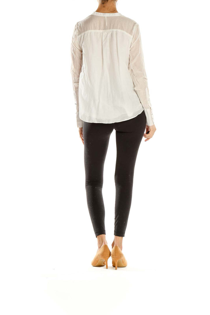 Back view of Free People white sheer blouse showing relaxed fit and gathered waist