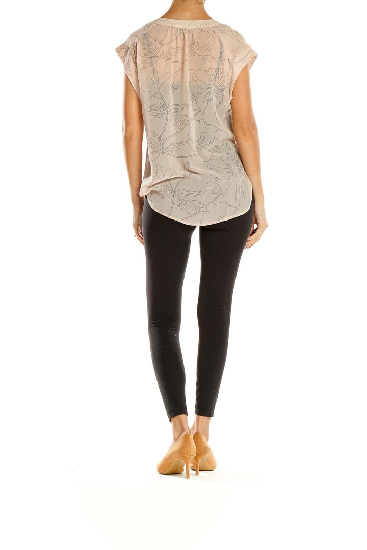 Side view of beige floral print V-neck blouse from BANANA REPUBLIC heritage with black leggings